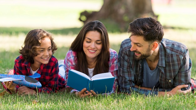 Parents and child reading while out together