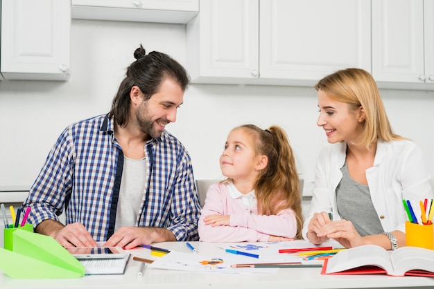 parents and daughter coloring together