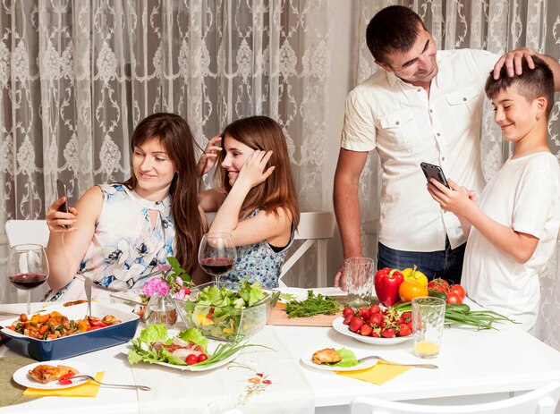 Parents enjoying their time with children at dinner table