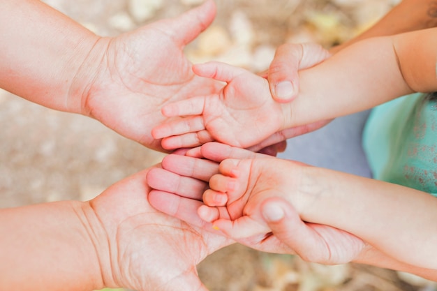 Parents holding hands of child