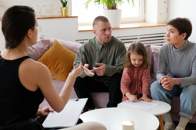 Free photo parents and kid doing therapy