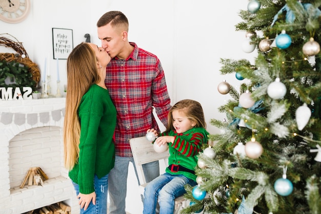 Parents kissing at christmas