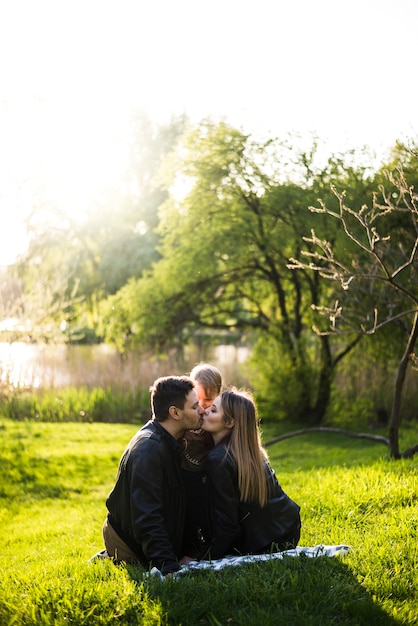 Parents kissing each other in park