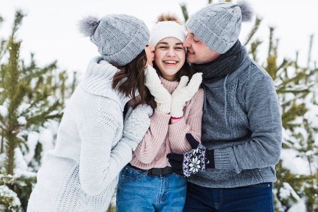 Parents kissing teenage daughter