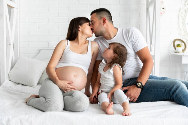 Parents kissing while daughter is looking at them