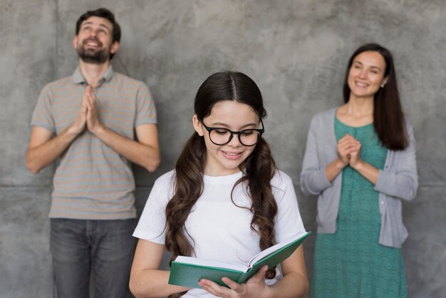 Parents listening to girl reading