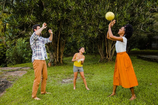 Parents playing ball with daughter