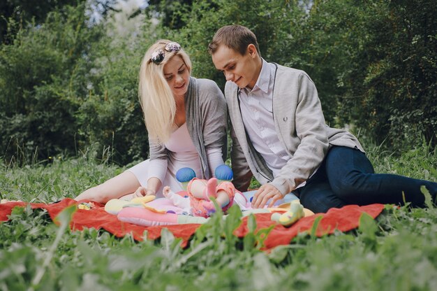 Parents playing and touching their baby