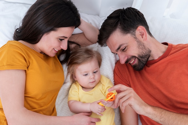 Free photo parents playing with baby baby