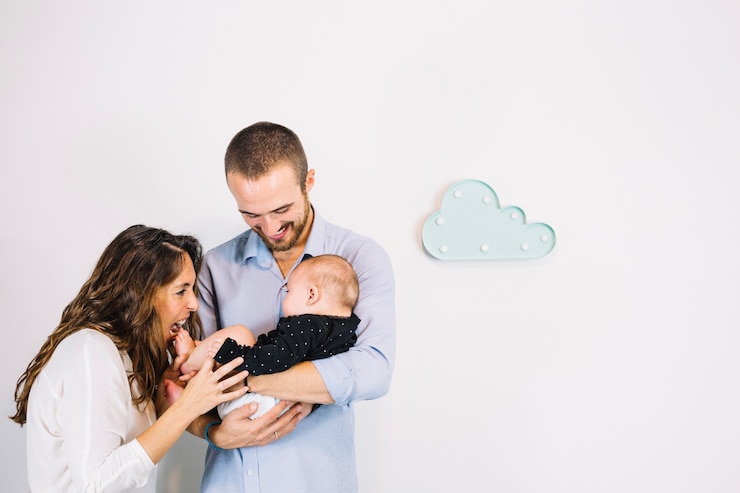 Free Photo parents playing with baby