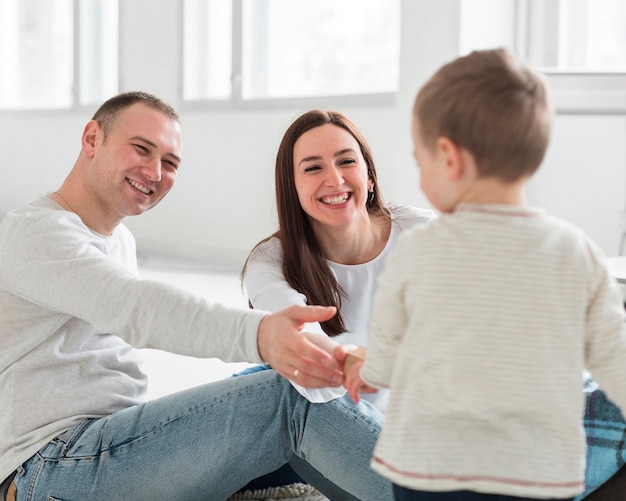 Free photo parents playing with child