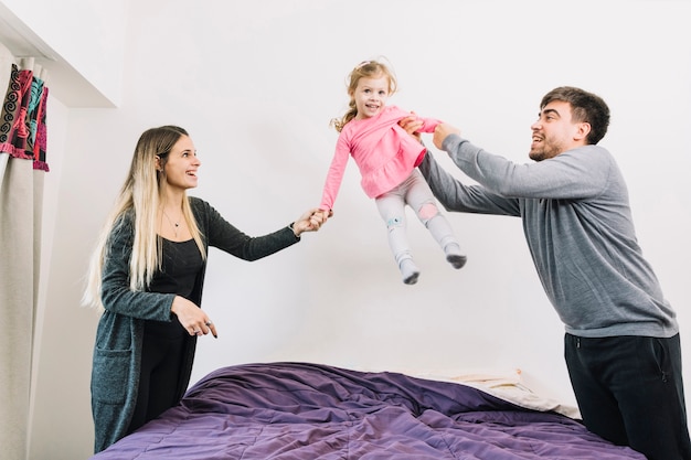 Parents playing with their daughter