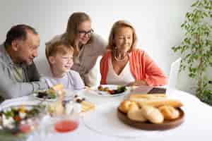 Free photo parents spending time with their daughter and grandson at home