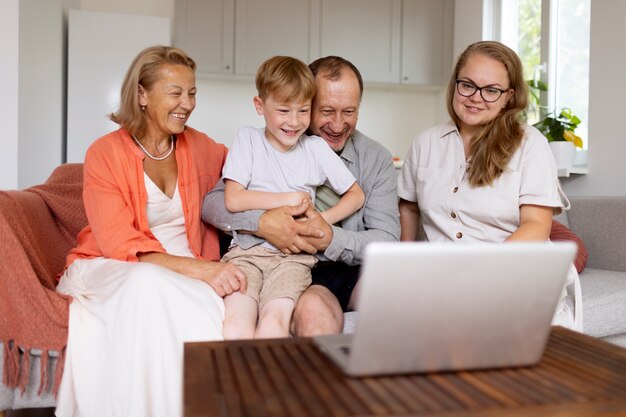 Parents spending time with their daughter and grandson at home