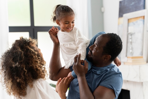 Parents spending time with their daughter at home