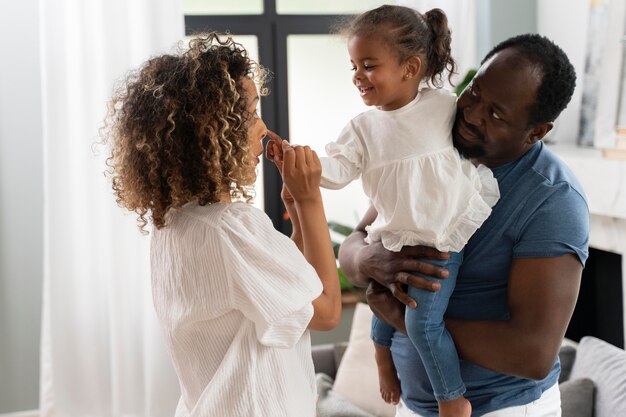 Parents spending time with their daughter at home