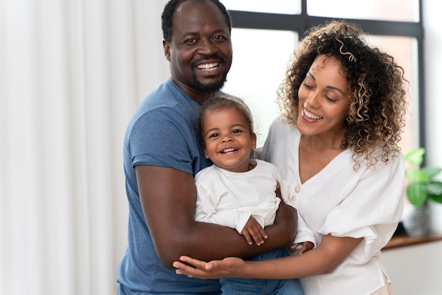 Parents spending time with their little daughter at home