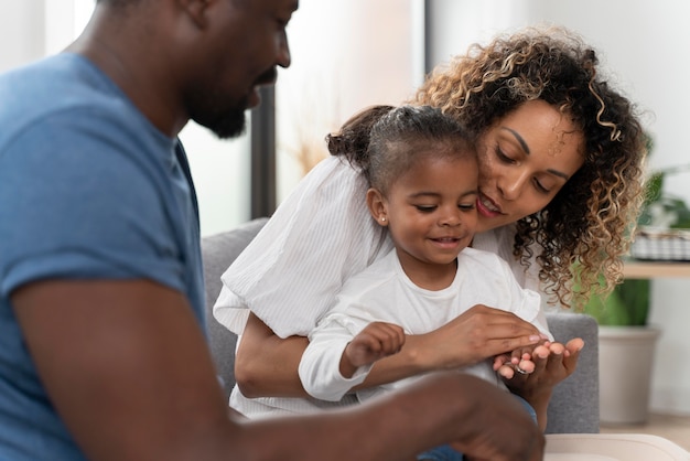 Parents spending time with their little daughter at home