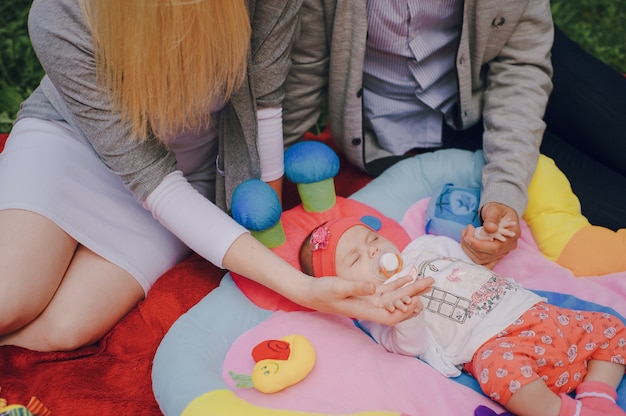 Free photo parents touching their baby's hands