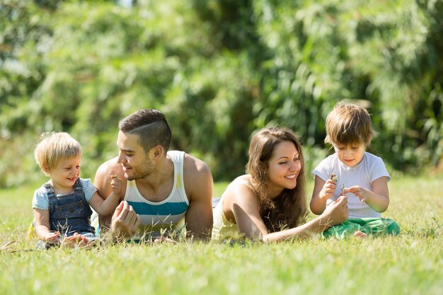 Parents with children laying in the grass