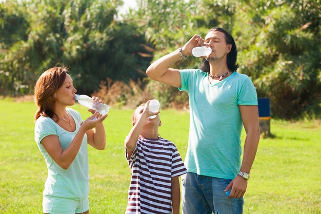 parents with teenager drinking from  bottles