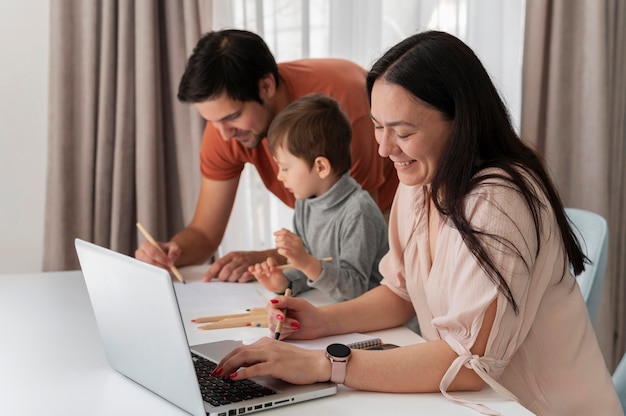 Parents working at home with kid