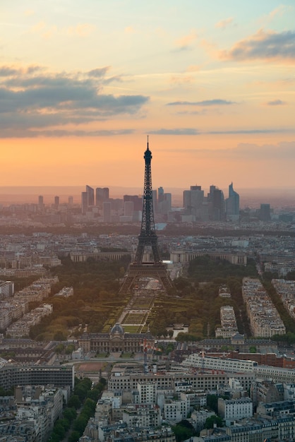 Paris city rooftop view with Eiffel Tower at sunset.