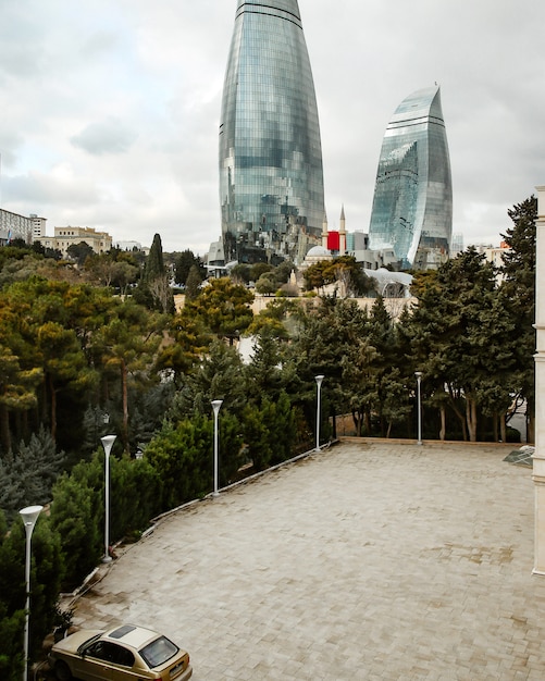 Parking lot near trees with city view to skyscrapers