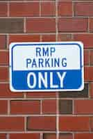 Free photo parking sign on brick wall closeup