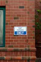 Free photo parking sign on brick wall front view
