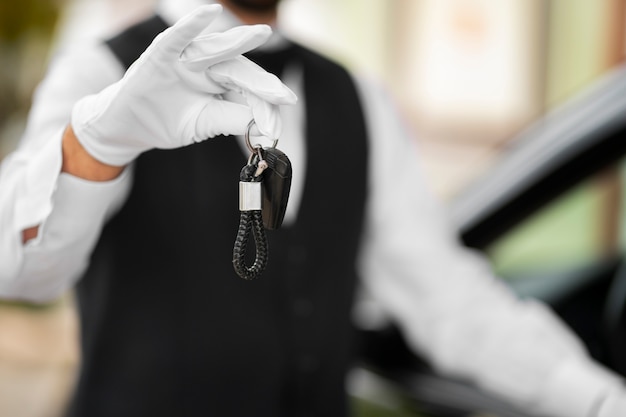 Free photo parking valet holding vehicle keys