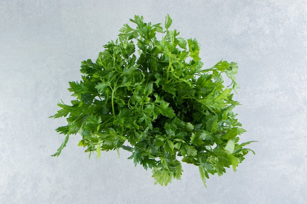 Free photo parsley in the white bucket , on the marble.