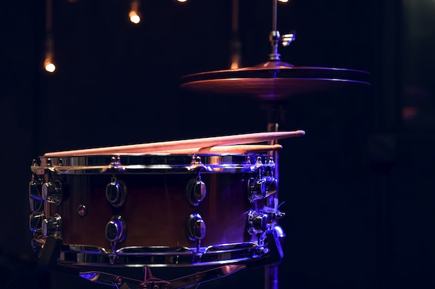 Part of a drum kit in the dark on a blurred background with boke.