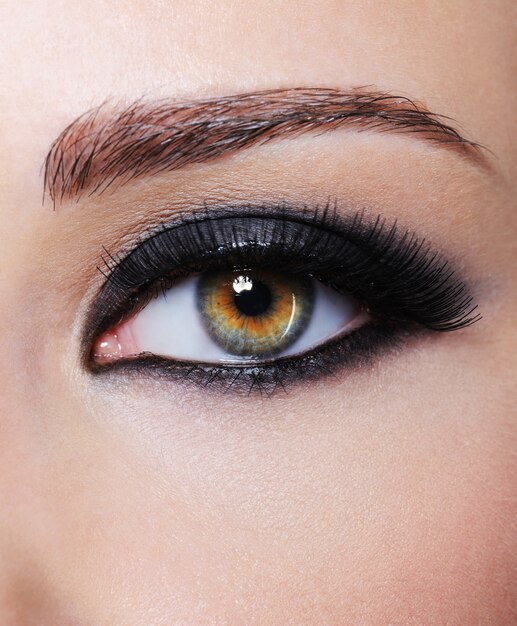 Part of female with eye with bright black glamour make-up - macro shot
