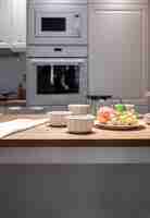 Free photo part of the kitchen interior with utensils and fruits on the table, modern kitchen.