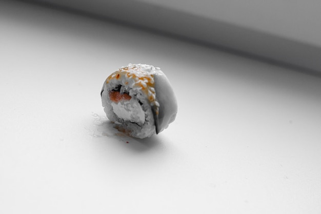Part of a sushi roll on a wooden background Philadelphia cheese