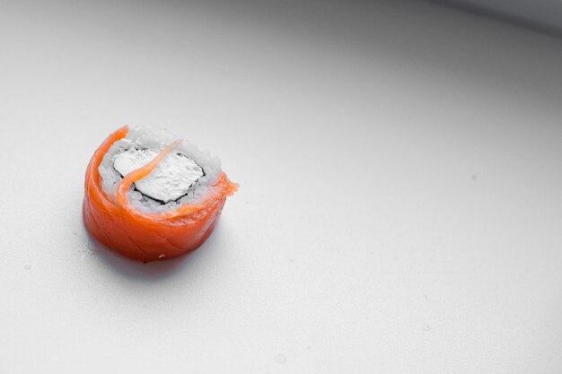 Part of a sushi roll on a wooden background Philadelphia cheese