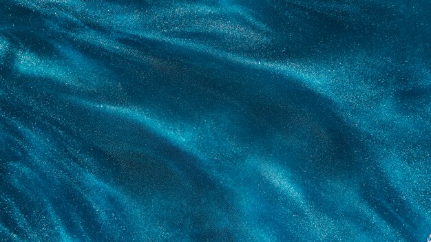 Particles of azure dye in water