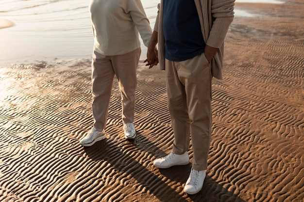 Free photo partners holding hands at seaside close up