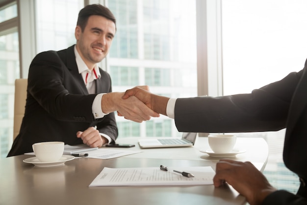 Partners shaking hands after singing contract