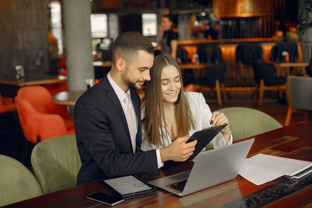 Partners sitting at the table and working in a cafe