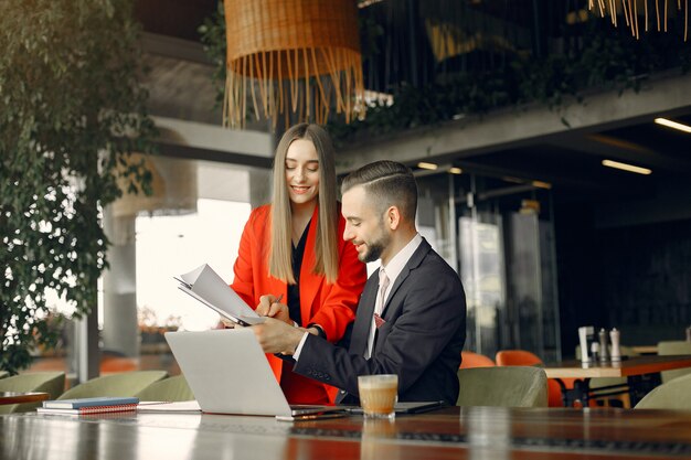 Partners sitting at the table and working in a cafe