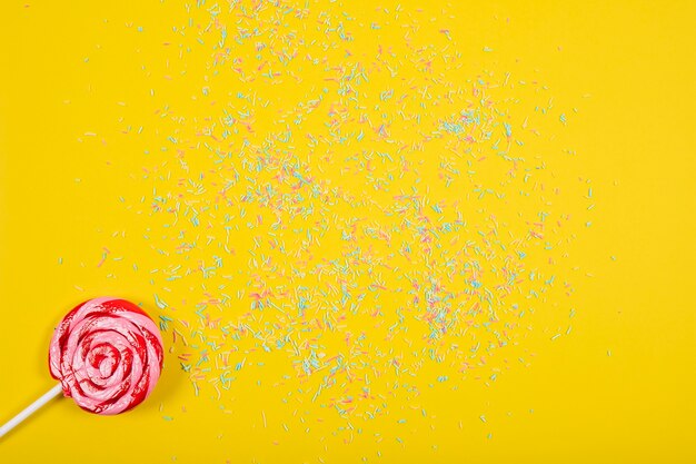 Party composition with lollipop and confetti