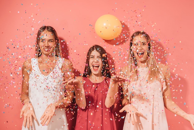 Party friends posing with confetti