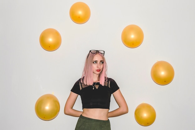 Free photo party girl looking at balloons