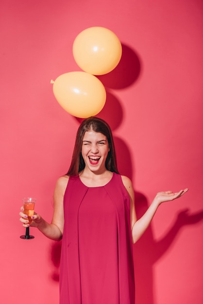 Party girl posing with balloons