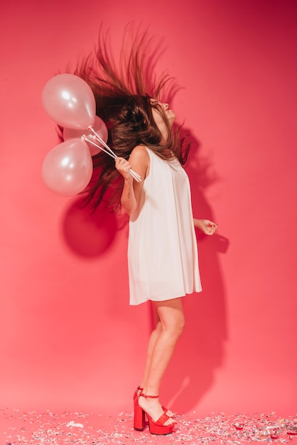 Free photo party girl posing with balloons