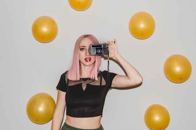 Free photo party girl with balloons and camera