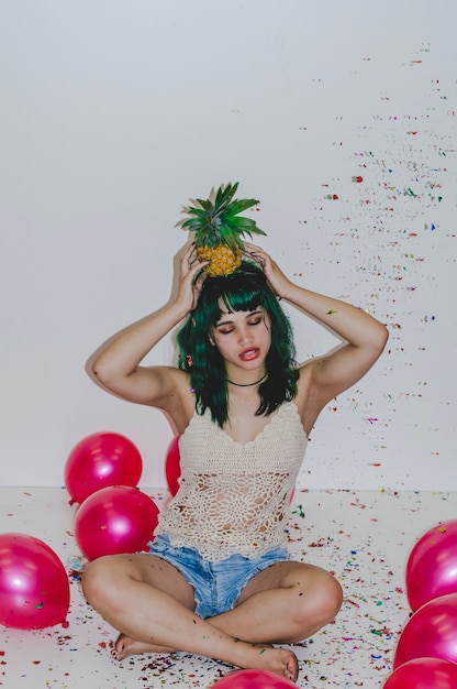 Free photo party girl with pineapple on head