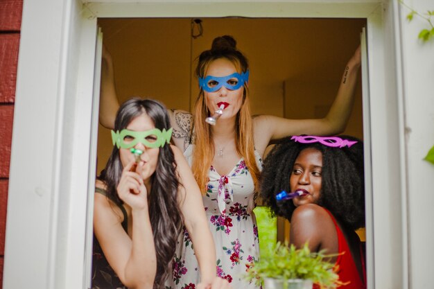 Party girls posing at the window